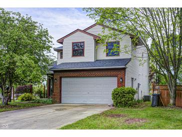 Charming two-story home featuring a two-car garage and a well-maintained lawn, creating a welcoming curb appeal at 305 Cardinal Dr, Whiteland, IN 46184
