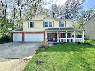 Charming two-story home with a brick-accented facade, attached garage, and inviting porch at 4223 Kestrel Ct, Indianapolis, IN 46254