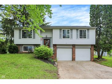 Two-story home featuring a front-facing two-car garage and well-maintained landscaping at 831 Wakulla Ct, Indianapolis, IN 46217
