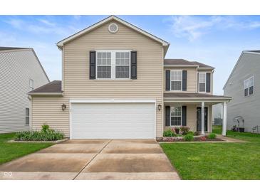 Charming two-story home features a two-car garage, well-kept lawn, and pleasant curb appeal at 9454 W Canoe Trl, Pendleton, IN 46064