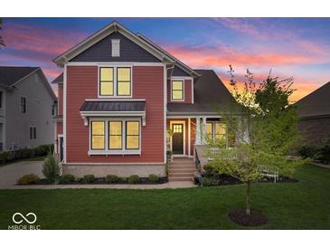 Charming two-story home featuring a well-manicured lawn and tasteful landscaping at 1013 Domino Dr, Carmel, IN 46032