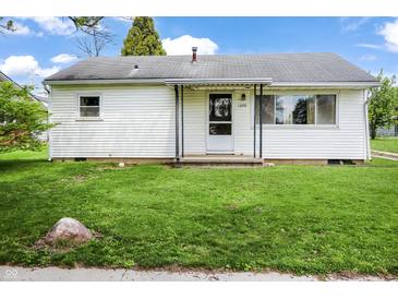 Charming single-story home with white siding, a covered porch, and a well-maintained green lawn at 1020 E Sixth St, Greenfield, IN 46140