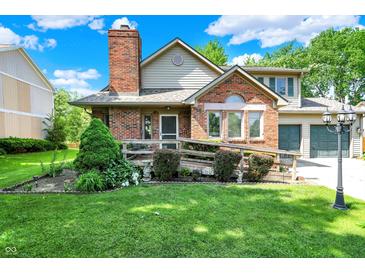 Charming two-story brick home with a manicured lawn and inviting front porch at 11620 E 75Th St, Indianapolis, IN 46236