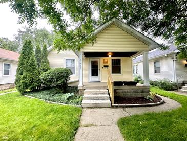 Charming single-Gathering home with a welcoming front porch and well-maintained landscaping at 1309 N Colorado Ave, Indianapolis, IN 46201