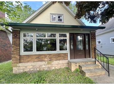 Charming bungalow featuring a brick foundation, and inviting front entrance at 2119 S Garfield Dr, Indianapolis, IN 46203