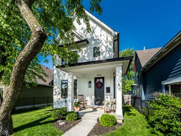 Charming two-story home with a beautifully landscaped front yard and inviting front porch at 544 N Beville Ave, Indianapolis, IN 46201