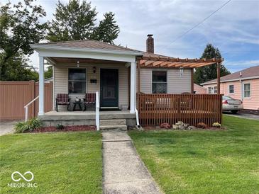 Charming single-story home featuring a covered porch, wood deck, and cozy curb appeal at 5450 E 18Th St, Indianapolis, IN 46218