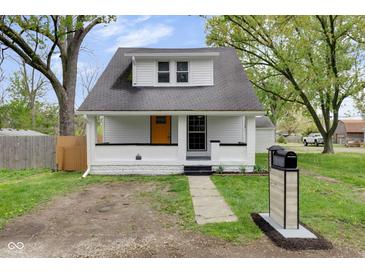Charming renovated home with a vibrant yellow front door and freshly painted white exterior at 555 S Auburn St, Indianapolis, IN 46241