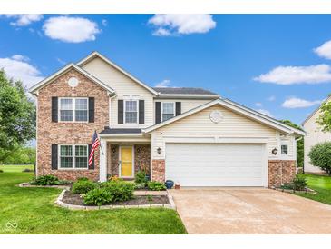 Charming two-story home with a brick and vinyl exterior, attached two-car garage, and landscaped front yard at 5617 Gainesway Dr, Greenwood, IN 46142