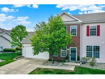 Charming two-story home featuring brick accents, neutral siding, and a well-manicured front lawn and landscaping at 9713 Springcress Dr, Noblesville, IN 46060