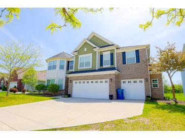 Inviting two-story home featuring a brick and siding exterior, a two-car garage, and a well-maintained front yard at 9993 Pepper Tree Ln, Noblesville, IN 46060