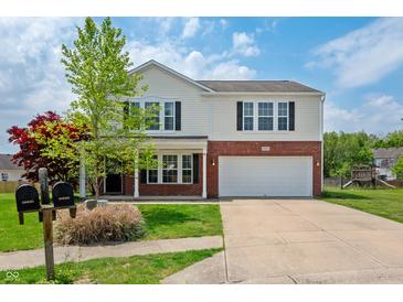 Charming two-story home with a well-maintained lawn, brick accents and an attached two-car garage at 10625 Gathering Dr, Indianapolis, IN 46259