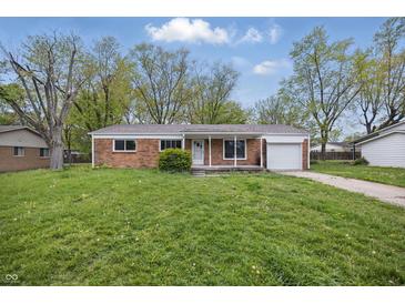 Charming brick ranch home with a one car garage and a well maintained lawn and landscaping at 1116 Heatherwood Dr, Indianapolis, IN 46241