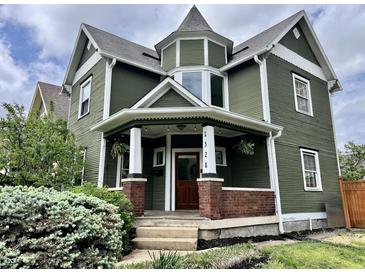 Charming two-story home featuring a unique turret design and a welcoming front porch at 1328 Sturm Ave, Indianapolis, IN 46202