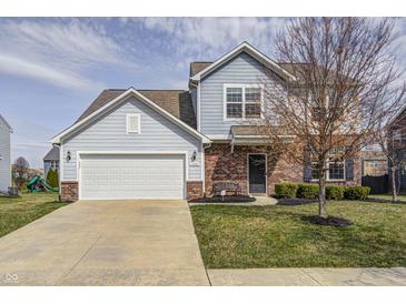Charming two-story home with attached garage and manicured front yard at 14584 Hinton Dr, Fishers, IN 46037