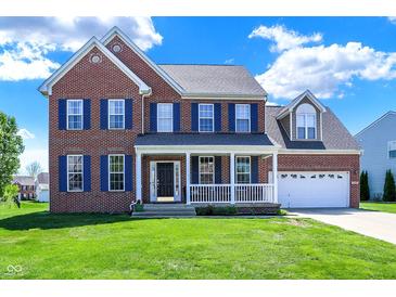 Two-story brick home featuring a welcoming front porch and a two-car garage with ample lawn space at 3101 Woodhaven Way, Bargersville, IN 46106