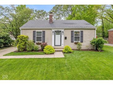 Charming single-story home featuring neutral paint, black shutters, manicured lawn, and tidy landscaping at 5526 Indianola Ave, Indianapolis, IN 46220