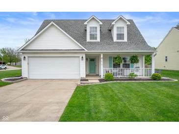 Charming home features a well-manicured lawn, two-car garage, and inviting front porch at 610 Redwood Dr, Pendleton, IN 46064