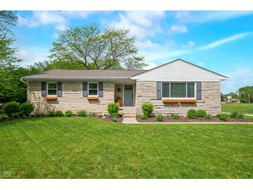 Charming stone home with a well-manicured lawn and inviting front entrance, perfect for curb appeal at 6250 Seminole Dr, Indianapolis, IN 46259