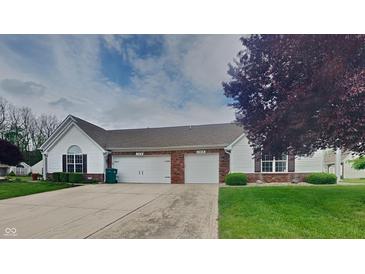 Charming exterior elevation of a two-car garage home with brick accents and well-manicured landscaping at 7018 Mallard Way, Plainfield, IN 46168