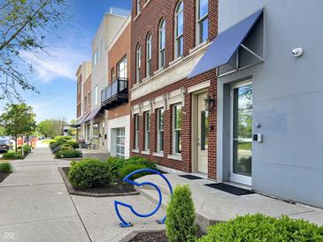 Beautiful townhome featuring brick and modern siding, with bike parking in a landscaped yard at 1026 Jackson St, Columbus, IN 47201