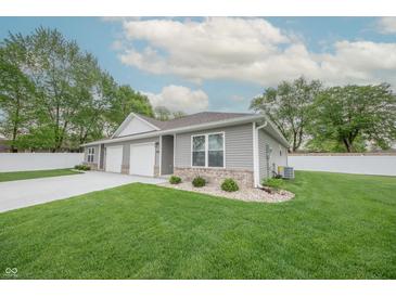 Charming home with a well-manicured lawn, gray siding, and a two-car garage, complete with tasteful landscaping at 1491 Coen Ct, Columbus, IN 47201