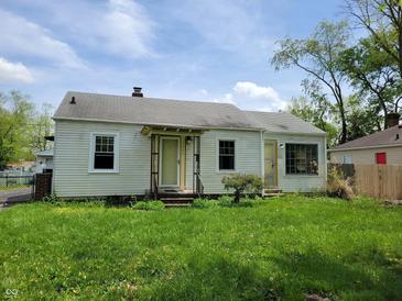 Charming single-story home with a well-manicured lawn and inviting front porch at 1507 N Luett Ave, Indianapolis, IN 46222