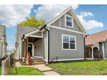 Charming gray home with a well-maintained lawn and inviting front porch at 202 Mckim Ave, Indianapolis, IN 46201