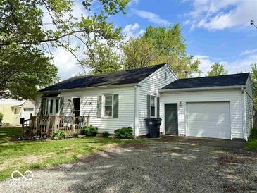 Charming single-story home with attached garage and a cozy front porch at 212 Vasbinder Dr, Chesterfield, IN 46017