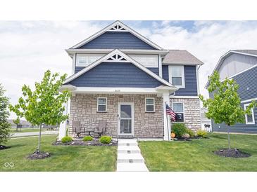 Charming two-story home with a stone facade, well-manicured lawn, and inviting front porch at 2628 Lamar Dr, Whitestown, IN 46075