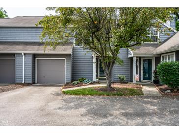 Charming townhome with grey wood siding, grey garage door, and inviting front yard landscaping at 2823 Somerset Bay, Indianapolis, IN 46240