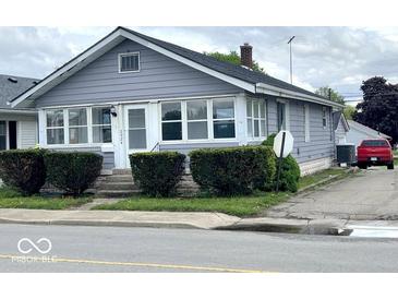 Charming home featuring large windows, a cozy front porch, and neat landscaping at 2924 Main St, Anderson, IN 46016