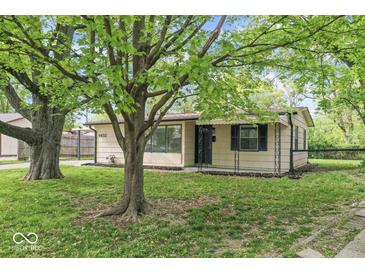 Charming single-story home featuring a well-maintained lawn and mature trees in a peaceful neighborhood at 4432 Brittany Rd, Indianapolis, IN 46222
