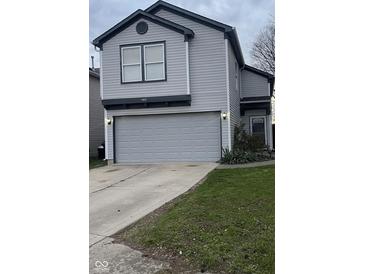 Charming two-story home with a gray vinyl siding and a two car garage at 562 Harmony Dr, Greenwood, IN 46143
