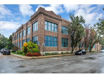 Beautiful brick apartment building featuring large windows and manicured landscaping at 735 Lexington Ave # Apt 27, Indianapolis, IN 46203