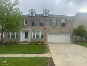 Traditional two-story brick home with a two-car garage and well-maintained lawn at 317 Legacy Blvd, Greenwood, IN 46143