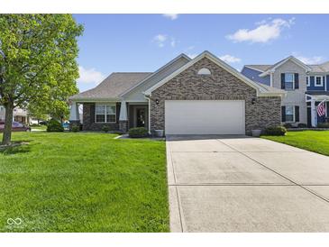 Charming brick home with a well-manicured lawn and a spacious two-car garage at 3311 Stoddard Pl, Indianapolis, IN 46217