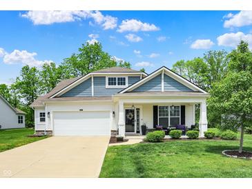 Charming two-story home with a well-manicured lawn and inviting front porch with beautiful curb appeal at 5580 Pintail Ln, Greenwood, IN 46143