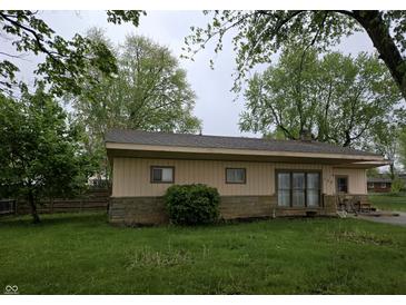 Cozy single-story home with a stone foundation, neutral siding, and a well-manicured green lawn at 109 N Avon Ave, Avon, IN 46123