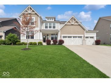 Beautiful two-story home with a well-manicured lawn and three car garage at 16264 Red Clover Ln, Noblesville, IN 46062