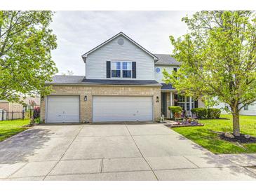 Charming two-story home features a spacious three-car garage and a well-maintained front yard at 1831 Whisperwood Trl, Danville, IN 46122