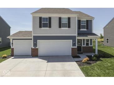Beautiful home with a two-car garage and well-manicured lawn at 192 Bluestem Ln, Whiteland, IN 46184