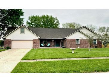 Charming brick ranch home with a well-manicured lawn and inviting covered front porch at 1934 Constitution St, Greenfield, IN 46140
