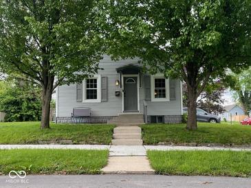 Charming gray two-story home with a well-manicured lawn and mature trees at 209 N Lincoln St, Martinsville, IN 46151