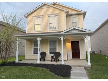 Charming two-story home featuring a welcoming front porch, manicured lawn, and inviting curb appeal at 2327 Bristol Dr, Franklin, IN 46131