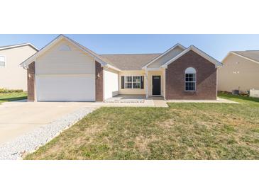 Charming single-story home with a brick and vinyl exterior and attached garage at 2761 Winding Creek Ln, Greenfield, IN 46140