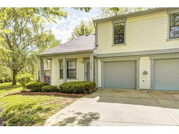 Charming two-story home featuring a well-manicured front yard and an attached two-car garage at 3187 Valley Farms Rd, Indianapolis, IN 46214