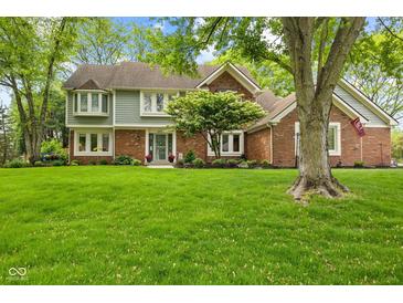 Charming two-story home with a well-manicured lawn and mature trees in a peaceful, established neighborhood at 4619 Allen Dr, Carmel, IN 46033