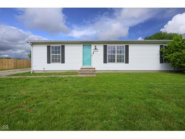 Cozy single-story home with a green lawn, quaint shutters, and a bright, inviting front door at 4632 Willowbrook Dr, Columbus, IN 47203