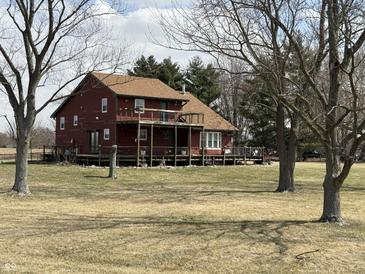 Charming two-story home with a large deck, perfect for outdoor entertaining and relaxing at 7140 N Michigan Rd, Fairland, IN 46126